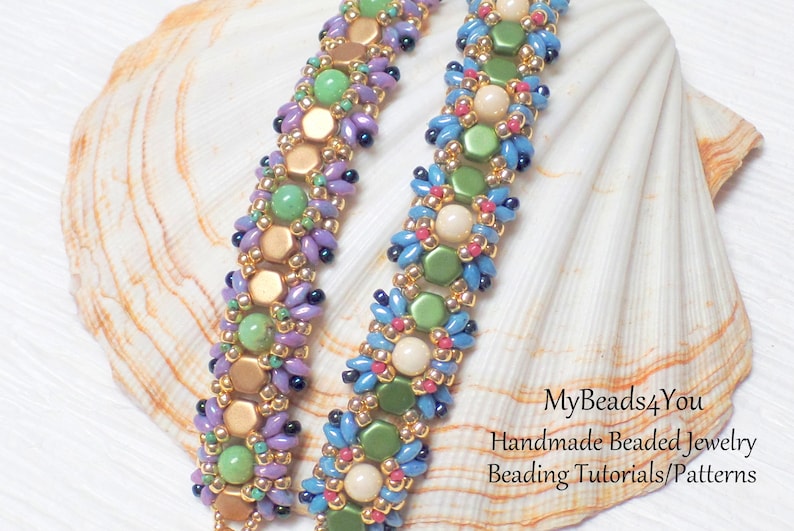 May include: Two beaded bracelets with a variety of colorful beads. The bracelets feature gold, green, purple, blue, and cream-colored beads. The bracelets are displayed on a white seashell.