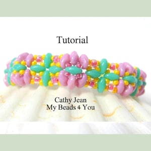 May include: A beaded bracelet with pink, turquoise, and yellow beads. The bracelet is made with a tutorial from Cathy Jean, My Beads 4 You. The word "Tutorial" is written at the top of the image.