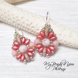 May include: A pair of teardrop-shaped earrings featuring a central round pink marbled bead surrounded by a ring of metallic silver seed beads and elongated coral-colored petal beads. The earrings hang from silver-toned hooks. Text reads My Beads4You Phoenix.