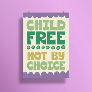 May include: A poster with the words "CHILD FREE NOT BY CHOICE" in green and yellow letters. The poster has a cream background with a purple scalloped border and is hanging against a purple background.