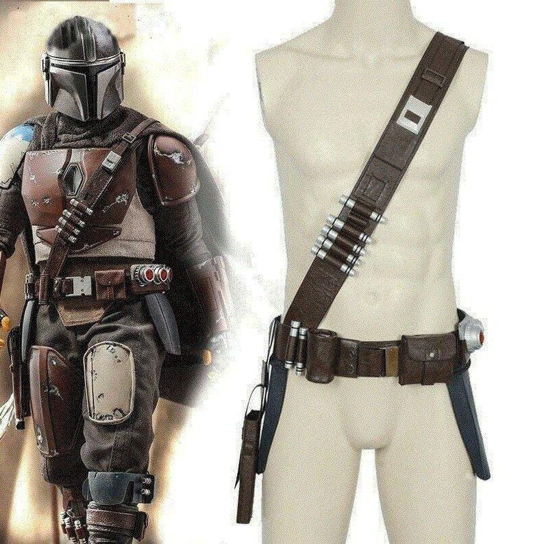 May include: A brown and tan Mandalorian costume with a helmet, chest armor, and belt with pouches and a holster. The costume includes a shoulder strap with silver bullet-shaped details. The overall design is detailed and realistic.