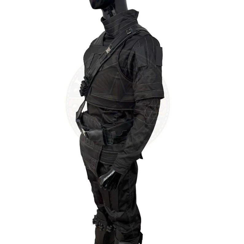 May include: A black tactical uniform featuring a high-neck long-sleeve shirt, a structured chest vest with a diagonal strap, and matching trousers. The ensemble includes multiple utility pockets, reinforced stitching, and metallic buckles.