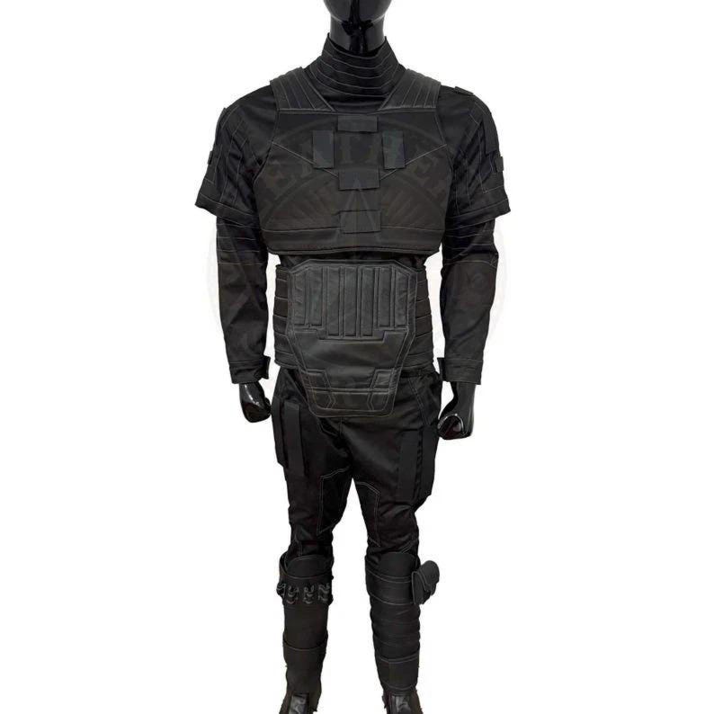 May include: A black tactical uniform set featuring a high-neck long-sleeve shirt, a structured chest plate with rectangular panels, a reinforced abdominal guard, and matching trousers with integrated leg padding and lower shin protective gear.