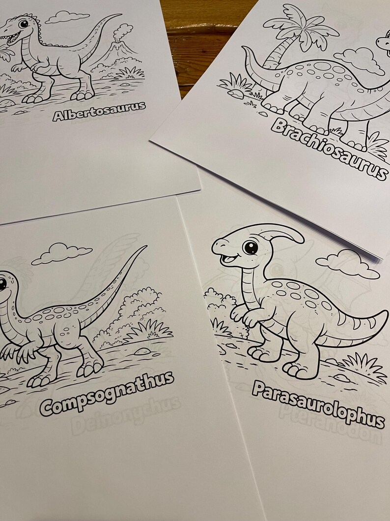 May include: Four white paper sheets featuring black line drawings of dinosaurs. The dinosaurs are labelled: Albertosaurus, Brachiosaurus, Compsognathus, and Parasaurolophus. Each dinosaur is depicted in a different pose, with a backdrop of plants and clouds.