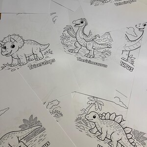 May include: A selection of dinosaur colouring pages. Each page displays a different dinosaur illustration with its name printed underneath. Dinosaurs include Triceratops, Velociraptor, and Wuerhosaurus. The illustrations are black and white line drawings.