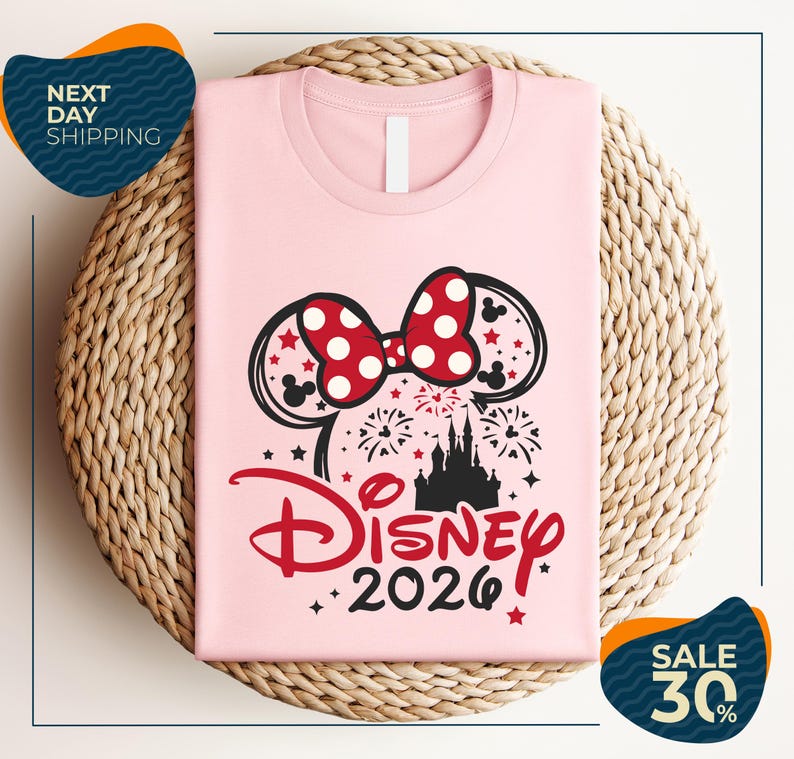 A pink t-shirt with a Disney-themed design, including a bow, fireworks, and a castle, along with the text "Disney 2020". The t-shirt is displayed on a woven basket, and there are two sale signs indicating a 30% discount.