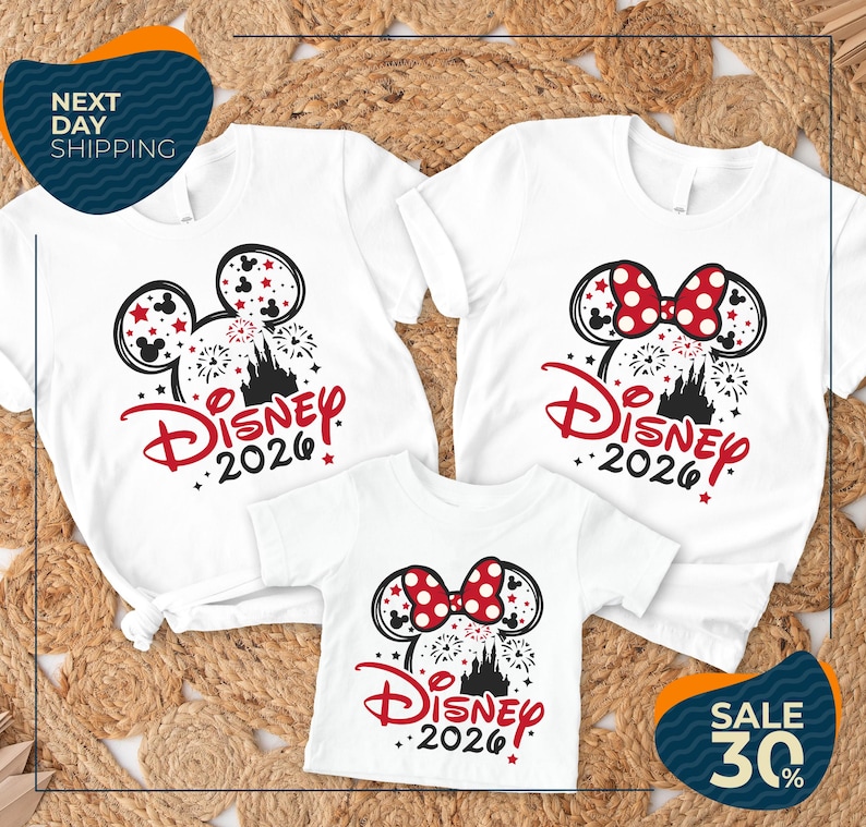 three Disney-themed t-shirts, each with a unique design and size, arranged on a bed of straw. The t-shirts are white with red and black accents, and the text "Disney 2020" is prominently displayed on each shirt. The t-shirts are arranged in a way that showcases their individual designs and sizes, creating a visually appealing and cohesive display.