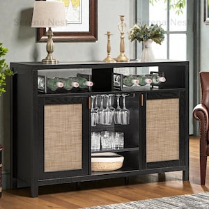 May include: Black wooden bar cabinet with wine bottle storage, glass racks, and woven door panels. The cabinet has a top shelf with a lamp, candlesticks, and a vase of flowers. The cabinet is designed for storing and displaying wine and glassware.