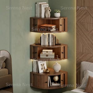 Corner Shelves Floating Wall Cabinet Set of 3, Fluted Corner Shelf with Sliding Doors and Walnut Finish | Floating Corner Shelf for Living Room Bedroom and Office | Space Saving Wall Storage

Empty corners are some of the most overlooked storage opportunities in any home. These corner shelves by Serena Nest turn every unused wall angle into a stylish, functional display space that works just as hard as it looks good.