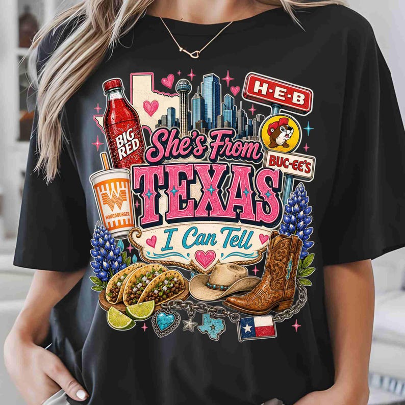 May include: A black t-shirt featuring a graphic print with the text "She's From TEXAS I Can Tell". The design includes a Big Red bottle, a Whataburger cup, a city skyline, H-E-B and Buc-ee's signs, tacos, a cowboy hat, a boot, and a Texas flag.