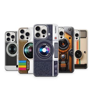 May include: A collection of phone cases with camera designs. The cases feature various camera lens and body styles, including retro and modern designs. The cases are in shades of black, brown, and beige, with colorful accents and the word "Insta".