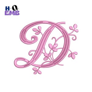 May include: A pink embroidered letter D featuring a cursive script font with decorative vine and leaf accents extending from the right side of the character. The design includes the text H of EMB in the upper left corner in blue and purple.