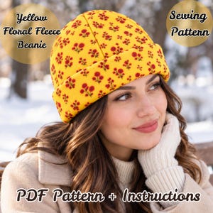 May include: A yellow fleece beanie featuring a repeating red floral pattern. The text on the image reads: Yellow Floral Fleece Beanie, Sewing Pattern, and PDF Pattern + Instructions. The beanie has a folded cuff and a rounded crown.