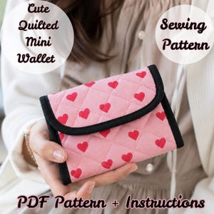 May include: A quilted mini wallet featuring a pink fabric with a repeating red heart pattern and black trim. The text on the image reads: Cute Quilted Mini Wallet, Sewing Pattern, PDF Pattern + Instructions.