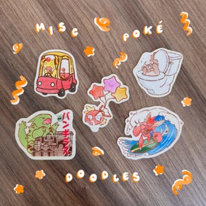 May include: A collection of five die-cut stickers featuring cartoon characters. One shows a yellow creature in a pink car, another a brown creature on a toilet, a third with colourful star balloons, a green monster with Japanese text, and a red creature surfing.