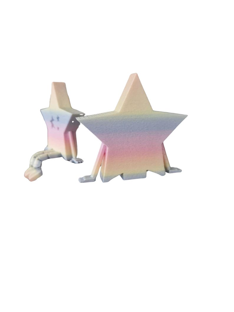 May include: Two star-shaped sculptures with pastel rainbow gradients. One star has a tail and small feet, the other has legs. The sculptures are in shades of pink, yellow, blue, and white.