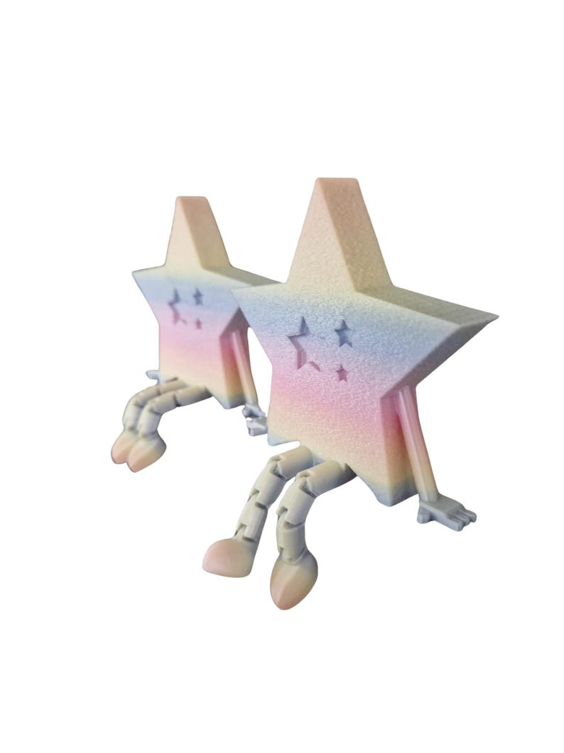 May include: Two star-shaped figurines with pastel rainbow gradients. Each star has articulated legs and arms, with a small star cutout. The color palette includes pink, blue, and yellow, creating a whimsical and playful aesthetic.