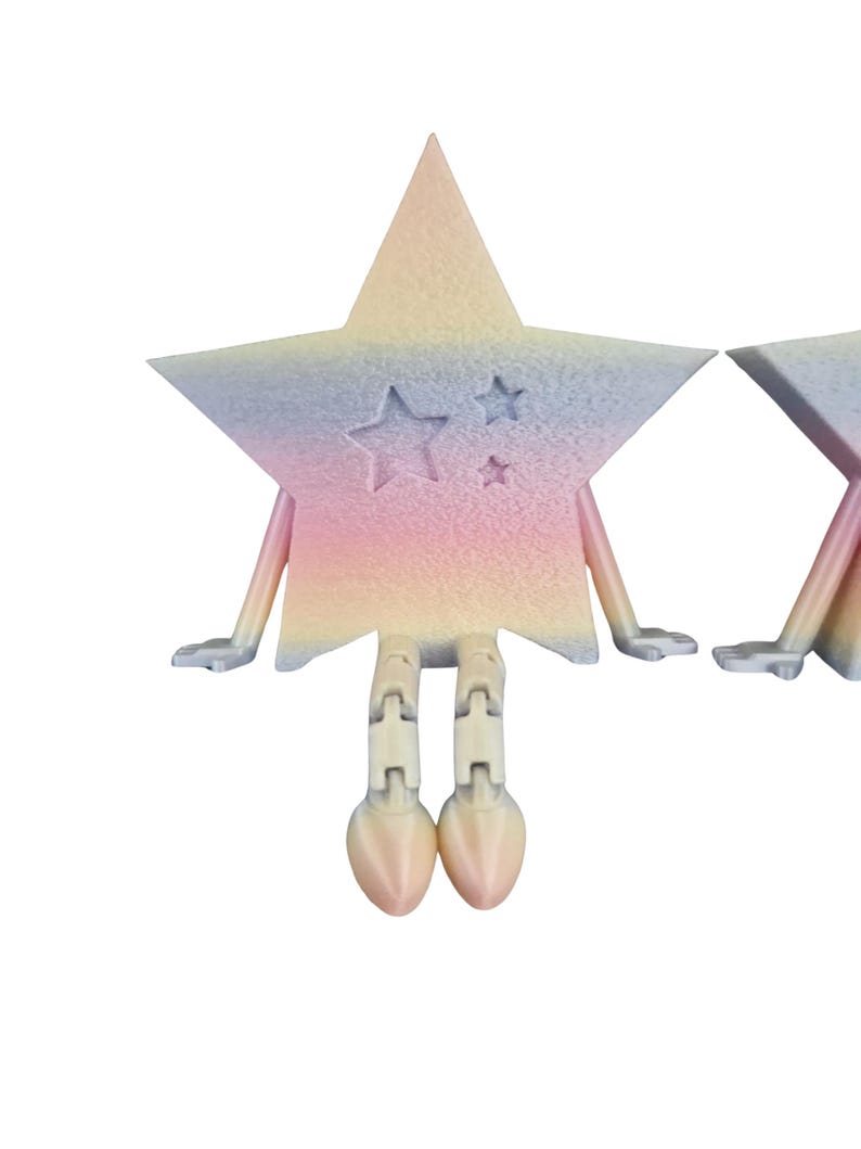 May include: A pastel-colored star-shaped figurine with arms and legs. The star has a gradient of pink, yellow, and blue hues. Three smaller stars are carved into the front. The legs end in rounded feet. The figurine is set against a white background.