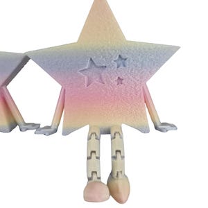 May include: A whimsical star-shaped figurine with a pastel rainbow gradient. The star has arms, hands, and segmented legs. Three smaller stars are carved into the front. The figurine is a unique decorative item.