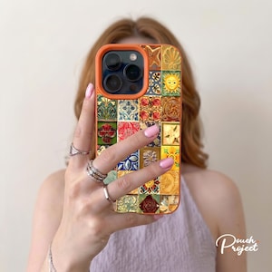 May include: A rectangular smartphone case with an orange border featuring a grid of colorful square tiles. The tiles display various intricate patterns including a yellow sun, a starfish, floral motifs, and geometric designs in shades of red, blue, green, and gold.