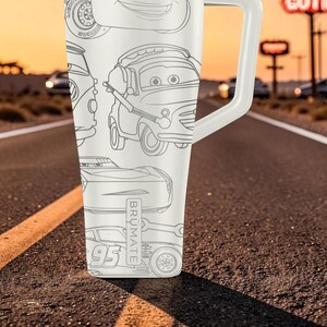 May include: A white insulated tumbler with a handle featuring a black line art pattern of various animated car characters. The design includes multiple vehicles with expressive eyes and the text BR&Uuml;MATE printed vertically on the side of the tumbler.