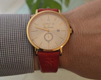 Orologio THRONE X LOS ANGELES 1.5 City Series con cinturino in pelle rossa e oro.