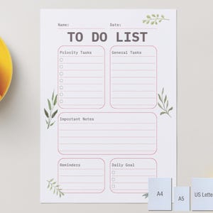May include: A white to-do list planner page featuring the text TO DO LIST, Name, Date, Priority Tasks, General Tasks, Important Notes, Reminders, and Daily Goal. The layout includes pink-lined sections and green leaf illustrations in the corners.