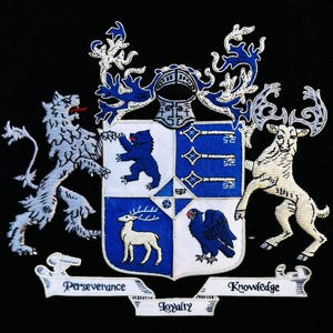 May include: Embroidered heraldic crest on black fabric. The crest features a shield with blue and white sections, a bear, deer, and bird. Flanking the shield are a lion and a deer. The words "Perseverance", "Knowledge", and "Loyalty" are displayed.