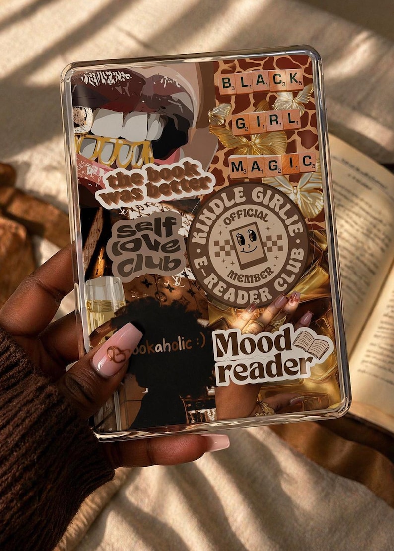 May include: A clear e-reader case decorated with various stickers including text that reads the book was better, self love club, Kindle Girlie E-Reader Club Official Member, bookaholic, and Mood reader, alongside images of lips, butterflies, and gold.