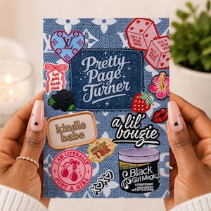 May include: A rectangular card with a blue denim-textured background featuring a repeating white floral pattern. It displays various colorful patches including a heart, dice, a black rose, a strawberry, and text reading Pretty Page Turner.