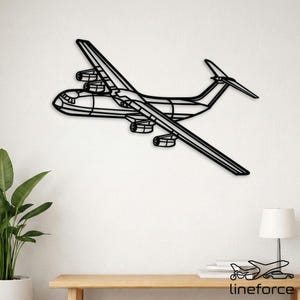 May include: Black metal airplane wall art. The artwork depicts a detailed outline of a large aircraft, including wings, engines, and tail. The design is mounted on a white wall, creating a striking contrast. The overall aesthetic is modern and minimalist.