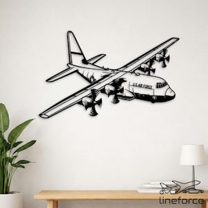 May include: A black metal wall art piece shaped like a C-130 Hercules military transport aircraft. The design features four propellers, a high-wing configuration, and the text U.S. AIR FORCE printed clearly on the side of the fuselage.