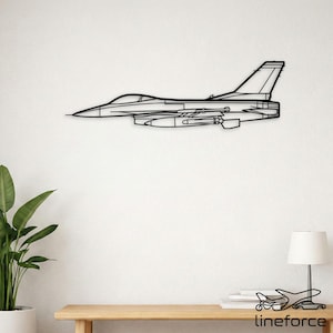 May include: A black metal wall art piece showing the outline of a fighter jet. The artwork, mounted on a white wall, features the jet's fuselage, wings, and tail. The design is a modern representation of an aircraft.