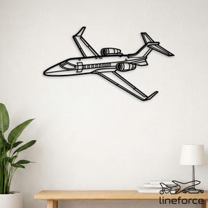 May include: Black metal wall art of a private jet. The artwork depicts the jet's silhouette, including wings, engines, and tail. The design is minimalist and modern, suitable for aviation enthusiasts or contemporary decor.