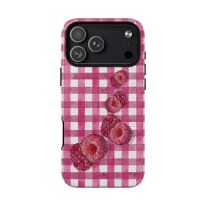 May include: A phone case with a pink and white gingham design and watercolour raspberries. The case has a glossy finish and a camera cutout for a multi-lens system.