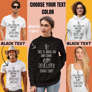May include: A collection of white and black apparel including a v-neck t-shirt, a hoodie, a crew-neck t-shirt, a tank top, and a sweatshirt, all featuring an upward-pointing arrow and the text: This is what an awesome Ruby developer looks like!