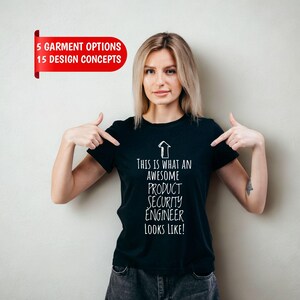 May include: A black short-sleeved t-shirt featuring a white upward-pointing arrow graphic and the text: This is what an awesome product security engineer looks like! The shirt also displays a red banner with the text: 5 garment options 15 design concepts.
