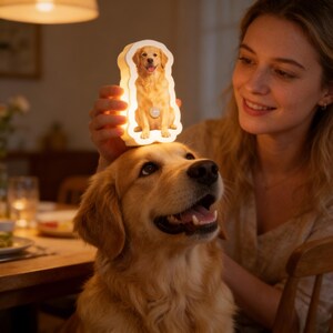 May include: A custom-shaped LED night light featuring a printed image of a golden retriever dog. The light emits a warm glow and has a small circular sensor on the front. The silhouette of the lamp matches the shape of the dog depicted on it.