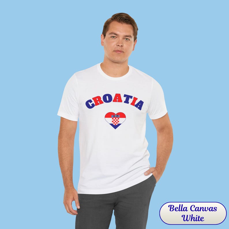 Model wearing a unisex Croatia shirt featuring a modern design with a heart-shaped Croatian flag detail on the chest. The look combines an aesthetic with a clean and minimal style. Suitable for both match days and everyday wear, this shirt offers a comfortable and versatile option for fans supporting Croatia, with a subtle yet distinctive expression of national pride.