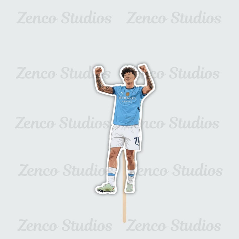 May include: A sticker featuring a cartoon illustration of a soccer player in a light blue jersey with the word "ETIHAD" on the front and the number 71 on the shorts. The player is celebrating with arms raised. The sticker is attached to a wooden stick.