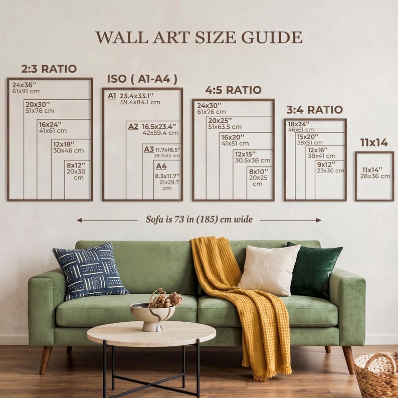 May include: A wall art size guide chart displaying various frame dimensions in inches and centimeters, categorized by ratios 2:3, ISO A1-A4, 4:5, 3:4, and 11x14. The text includes a reference stating the sofa is 73 inches wide for scale.