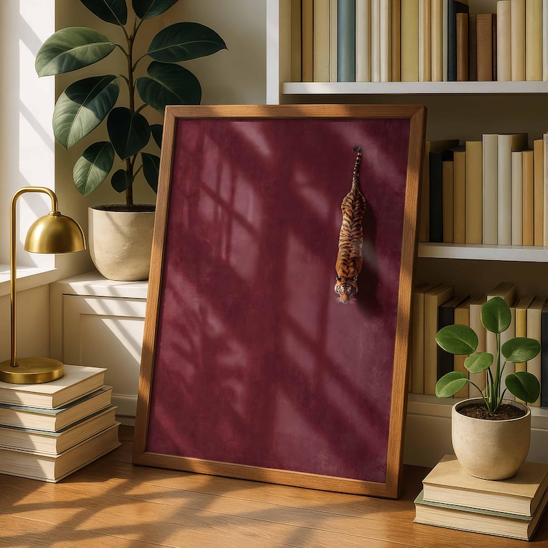 May include: A rectangular wooden frame containing a solid deep burgundy background with a small, realistic tiger figure positioned vertically in the center. The frame is displayed upright, showcasing a smooth, matte surface texture within the border.