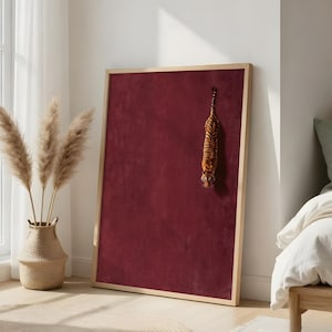 May include: A rectangular bulletin board with a deep burgundy velvet-textured surface and a light-toned wooden frame. A small, plush tiger figurine with orange and black stripes is attached to the upper right section of the board's surface.