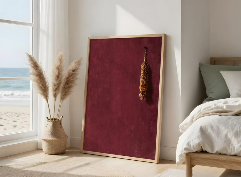 May include: A rectangular bulletin board with a deep burgundy velvet-textured surface and a light-toned wooden frame. A small, plush tiger figurine with orange and black stripes is attached to the upper right section of the board's surface.