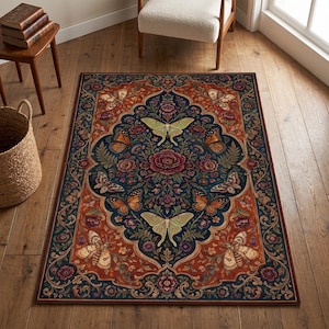 May include: A rectangular area rug featuring a dark blue central medallion surrounded by a deep orange border. The design includes symmetrical floral patterns, green foliage, and various moths and butterflies in shades of cream, orange, and brown.