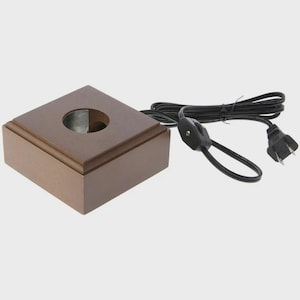 May include: A brown wooden display base with a circular opening and a black power cord. The base is square with a beveled edge. The power cord has a switch and a two-prong plug.