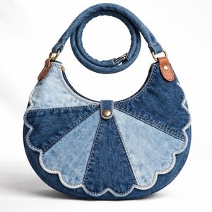 May include: A denim handbag with a unique, half-moon shape. The bag features a patchwork design of various blue denim shades, a scalloped edge, and a matching denim strap. Brown leather accents and a brass clasp complete the design.
