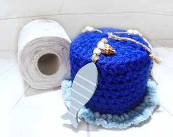 Maritime toilet roll hat with shells and wooden fish, dark blue crocheted