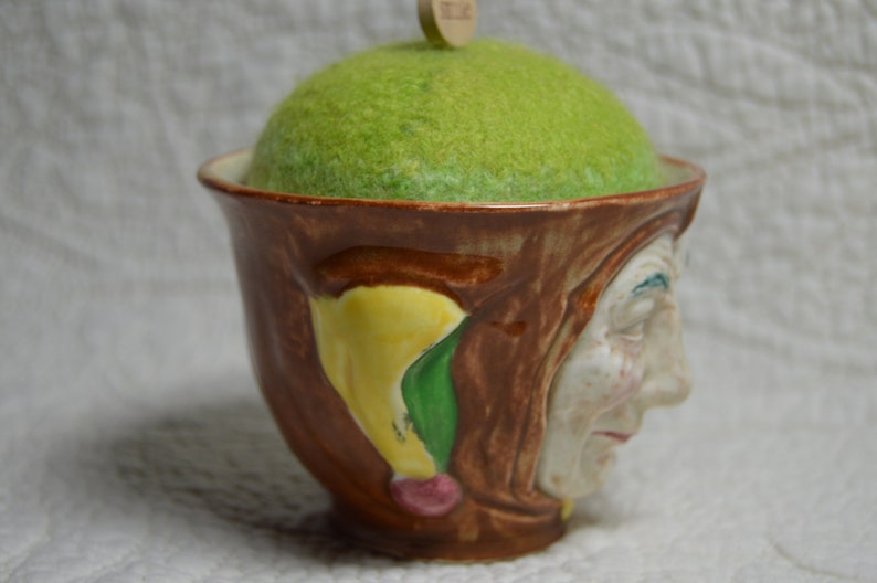 Hand-knitted felted wool pincushion in vintage Toby mug