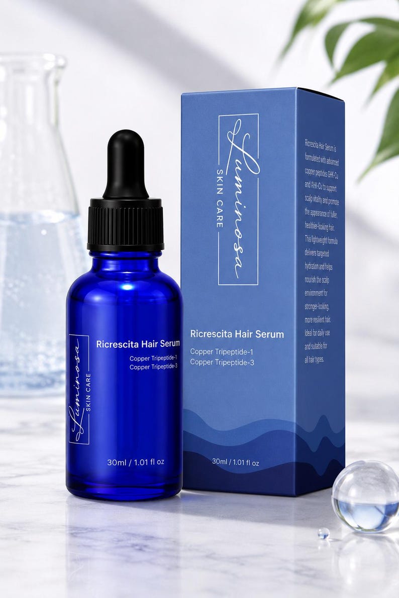 May include: A cobalt blue glass dropper bottle and matching rectangular box labeled Luminosa Skin Care Ricrescita Hair Serum with Copper Tripeptide-1 and Copper Tripeptide-3. The packaging indicates a volume of 30ml / 1.01 fl oz for the hair treatment.